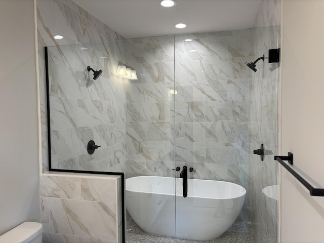 bathroom featuring a freestanding tub, toilet, recessed lighting, and tiled shower