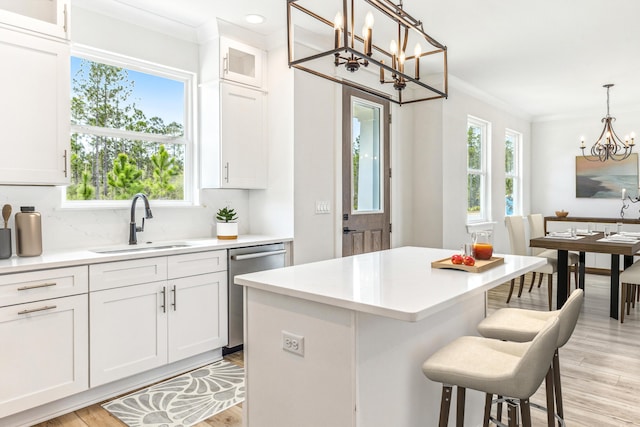 403 Bear Creek Blvd, Freeport, FL 32439 - kitchen with a chandelier, dishwasher, crown molding, a kitchen breakfast bar, and plenty of natural light