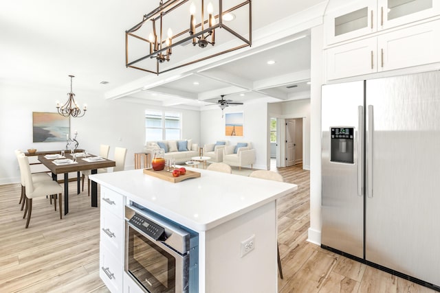 403 Bear Creek Blvd, Freeport, FL 32439 - kitchen with appliances with stainless steel finishes, a chandelier, light wood finished floors, a center island, and white cabinets