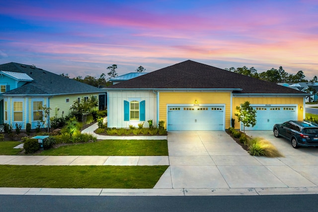 ranch-style house with a garage and a lawn