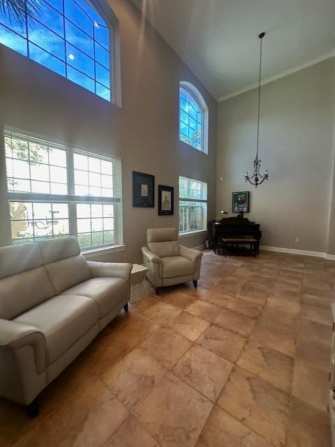 living room with ornamental molding and a high ceiling