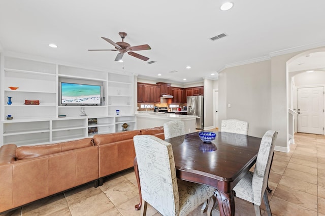 dining space with crown molding, ceiling fan, and built in shelves