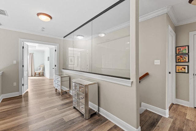 hall featuring ornamental molding and wood-type flooring