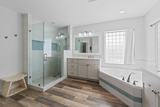 bathroom featuring vanity, hardwood / wood-style floors, and independent shower and bath