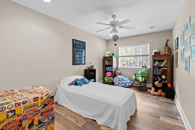 bedroom with ceiling fan and light hardwood / wood-style floors