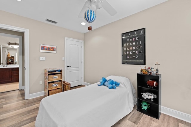 bedroom with sink, ceiling fan, and light wood-type flooring