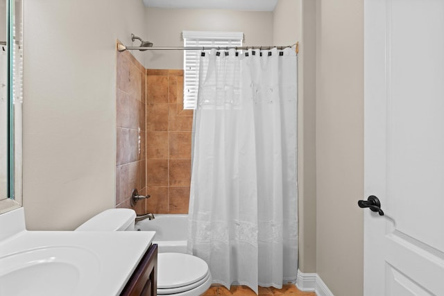 full bathroom with shower / tub combo with curtain, vanity, and toilet