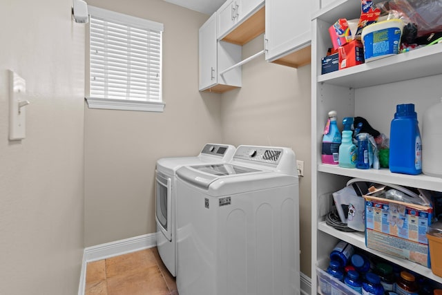 laundry area with separate washer and dryer, cabinets, and light tile patterned flooring