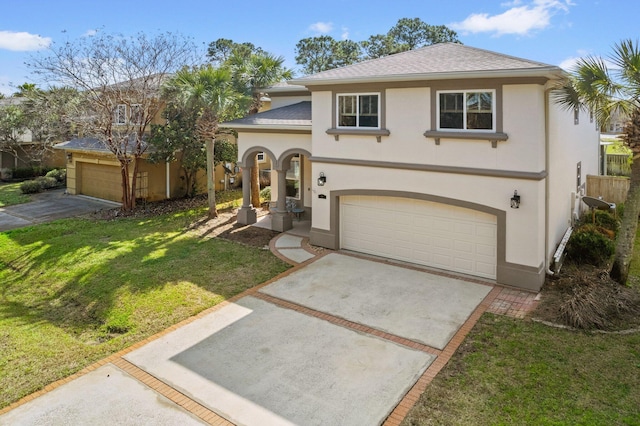 mediterranean / spanish home featuring a garage and a front lawn