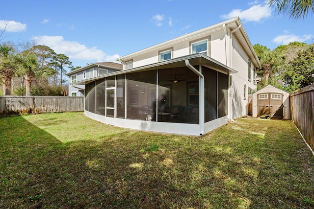 back of house with a yard, a shed, and a sunroom