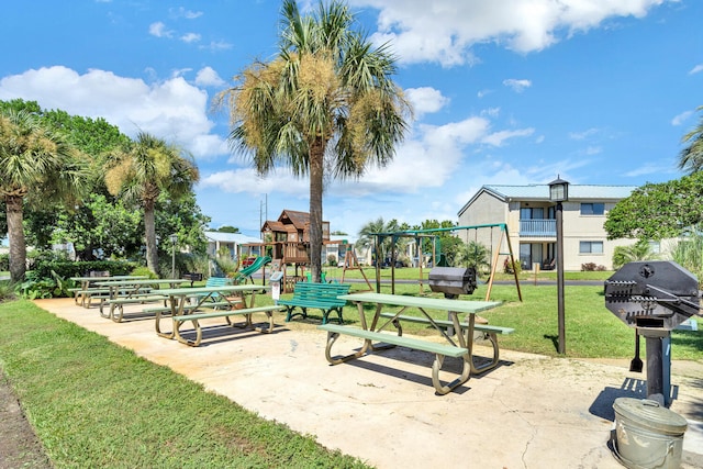 view of community featuring playground community and a lawn