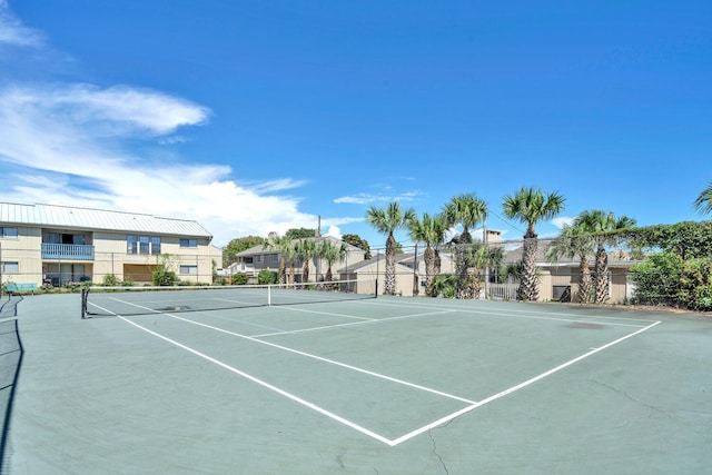 view of sport court with a residential view and fence