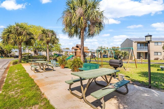 view of community with a lawn and playground community