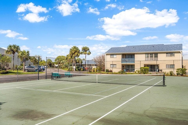 view of sport court featuring fence