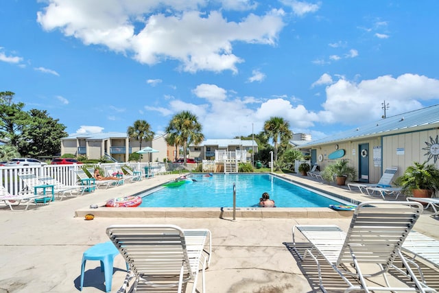 pool featuring a patio and fence