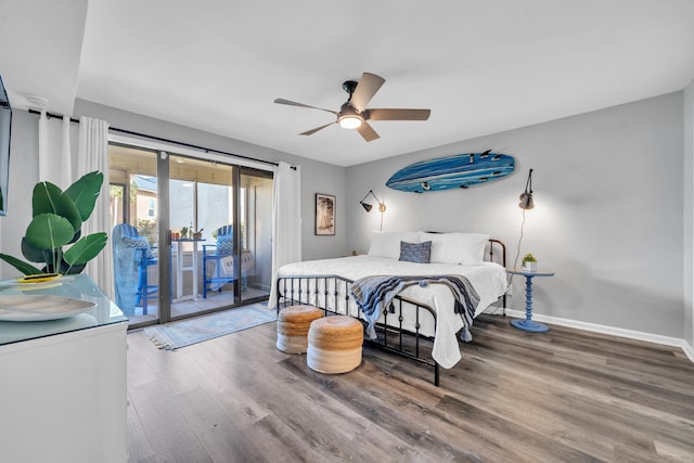 bedroom with access to exterior, a ceiling fan, baseboards, and wood finished floors