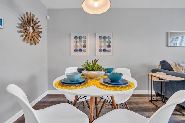 dining room with wood finished floors and baseboards