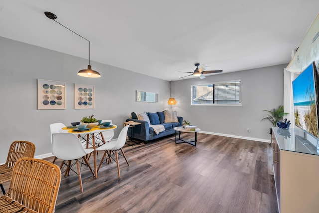 living room featuring visible vents, dark wood-type flooring, a ceiling fan, and baseboards