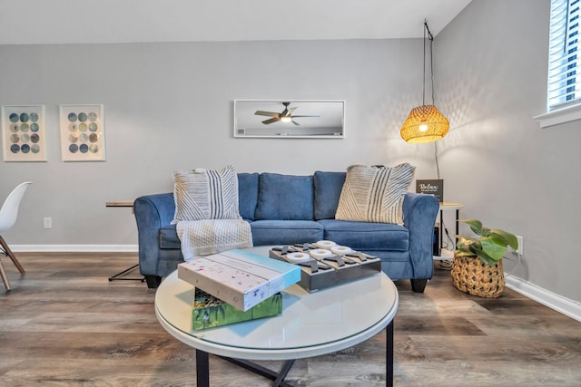 living area featuring wood finished floors and baseboards