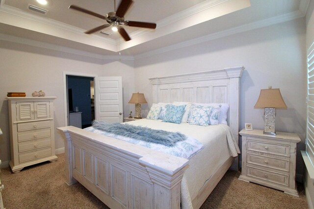 bedroom featuring crown molding, a raised ceiling, ceiling fan, and carpet floors