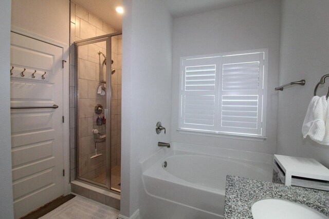 bathroom featuring vanity and independent shower and bath