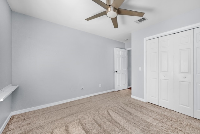 unfurnished bedroom featuring ceiling fan, a closet, and carpet