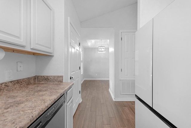 kitchen featuring white cabinets, dishwasher, light wood-type flooring, and vaulted ceiling