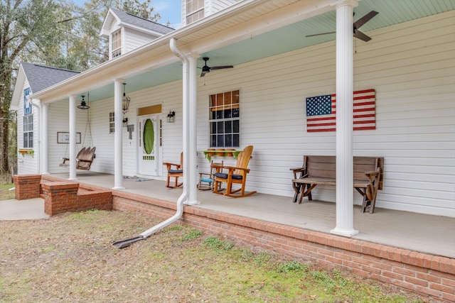 doorway to property with ceiling fan and a porch