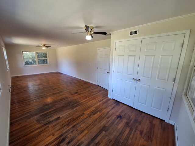 unfurnished bedroom featuring ceiling fan, dark hardwood / wood-style floors, and ornamental molding