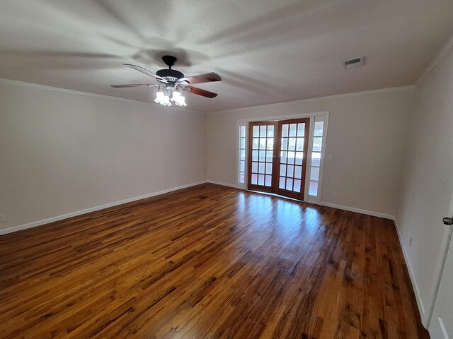 spare room with ornamental molding, ceiling fan, dark hardwood / wood-style floors, and french doors