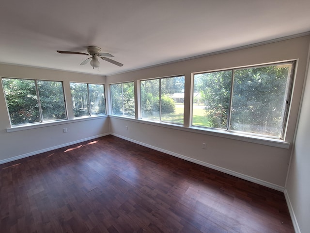 empty room with dark hardwood / wood-style flooring and ceiling fan