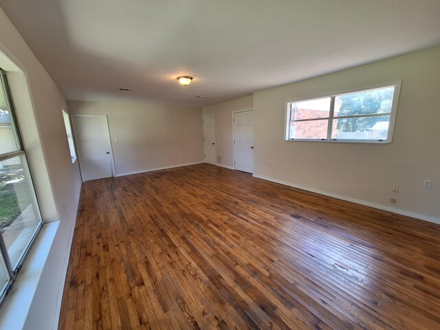 empty room with dark hardwood / wood-style floors