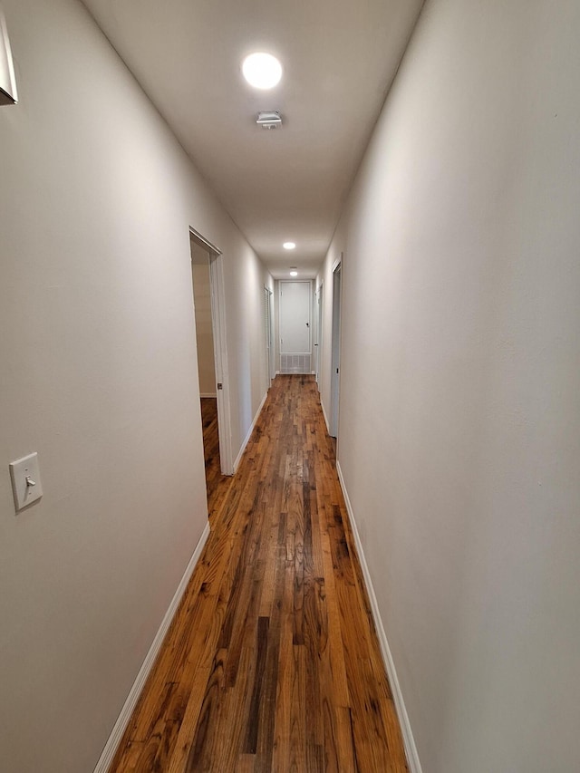 corridor featuring dark wood-type flooring