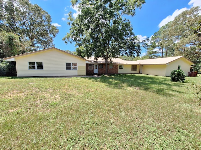 rear view of house with a yard