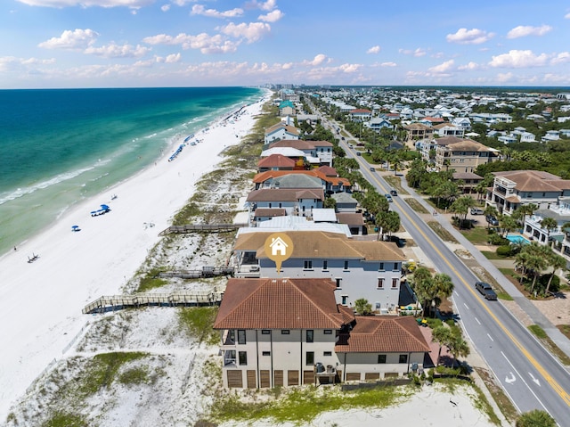 aerial view featuring a residential view, a view of the beach, and a water view