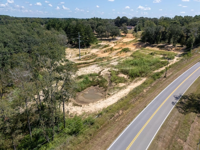 birds eye view of property with a wooded view