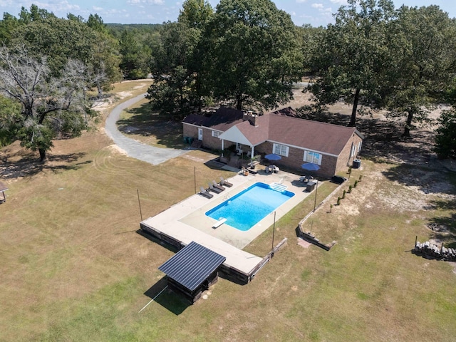 view of swimming pool with a diving board and a patio