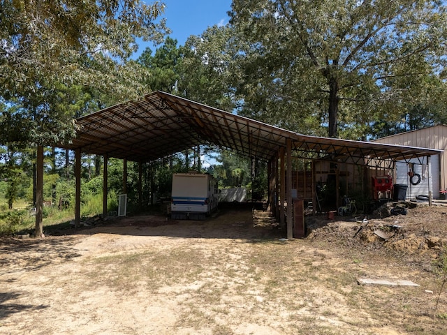 view of vehicle parking with driveway and a carport