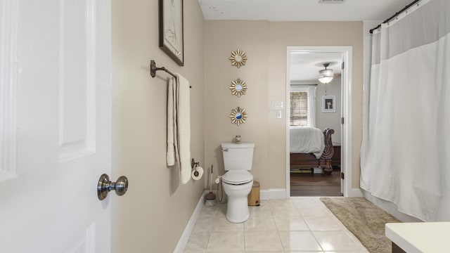 full bath featuring curtained shower, visible vents, toilet, baseboards, and tile patterned floors