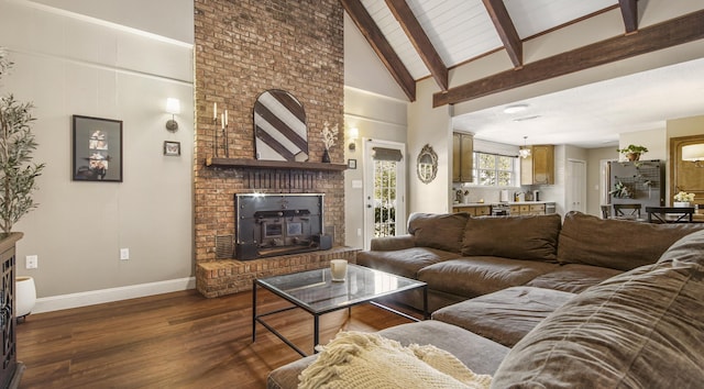 living room with baseboards, dark wood finished floors, beamed ceiling, a brick fireplace, and high vaulted ceiling