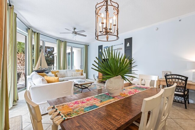 dining space featuring ceiling fan with notable chandelier, light tile patterned floors, and ornamental molding