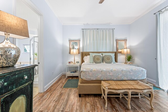 bedroom with crown molding, ceiling fan, and wood-type flooring