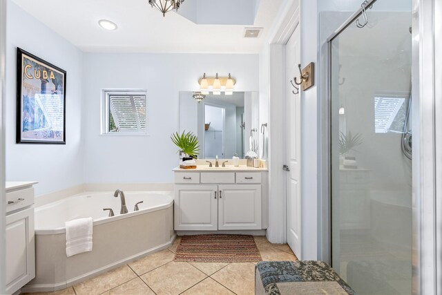 bathroom with tile patterned flooring, vanity, and shower with separate bathtub