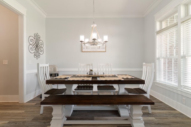 dining area with ornamental molding, an inviting chandelier, and dark hardwood / wood-style floors