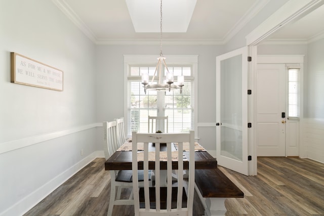 dining room featuring ornamental molding, dark wood-type flooring, and plenty of natural light