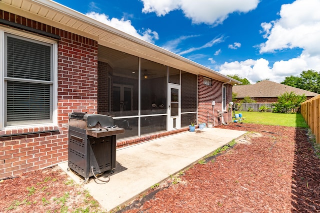 back of property featuring a patio area and a sunroom