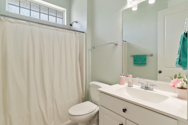 bathroom with vanity, toilet, and a shower with curtain