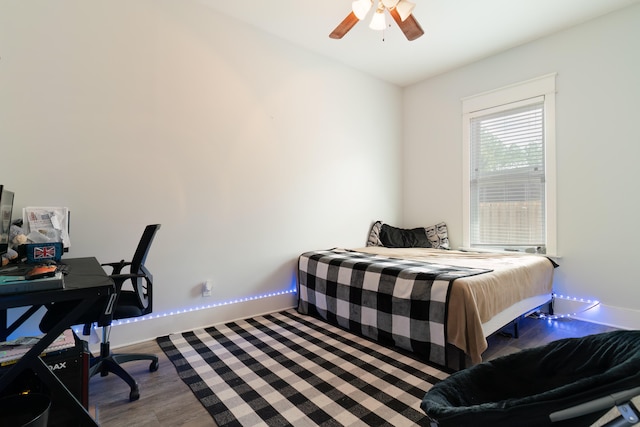 bedroom with hardwood / wood-style floors and ceiling fan