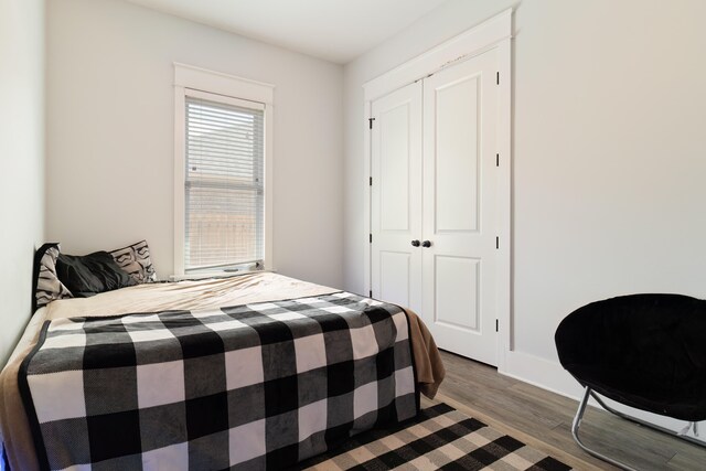 bedroom featuring a closet and dark hardwood / wood-style flooring