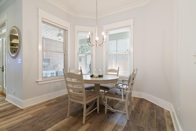 dining room with a healthy amount of sunlight, ornamental molding, and dark hardwood / wood-style flooring